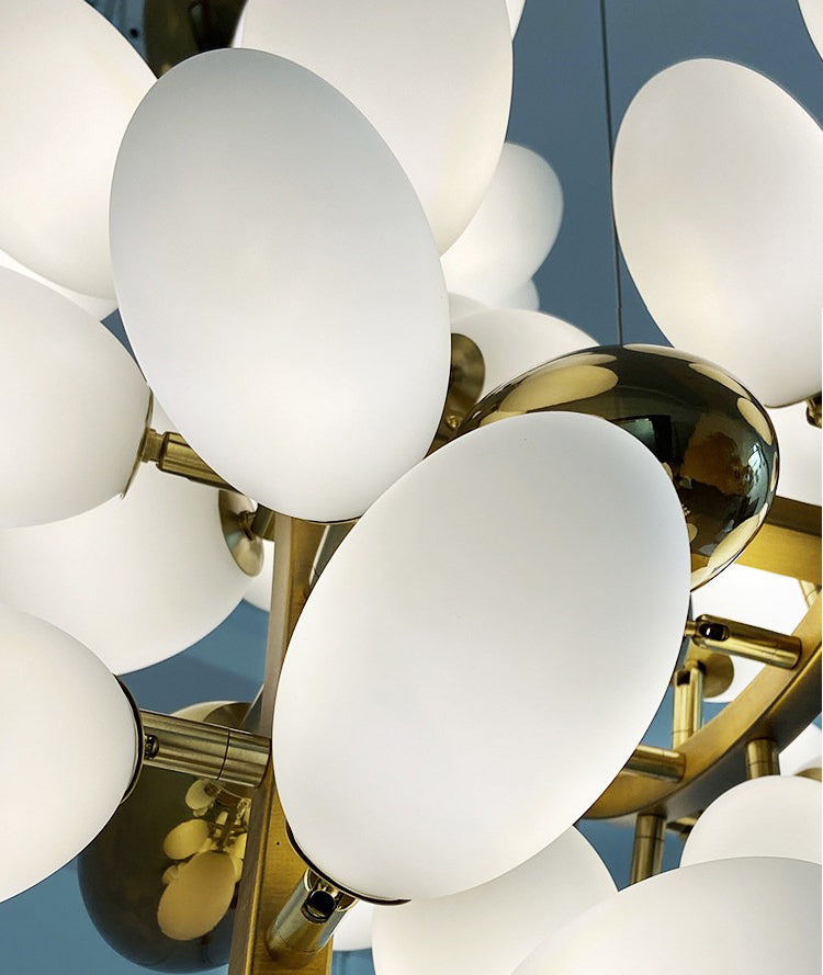 Close-up of white glass shades on organic chandelier