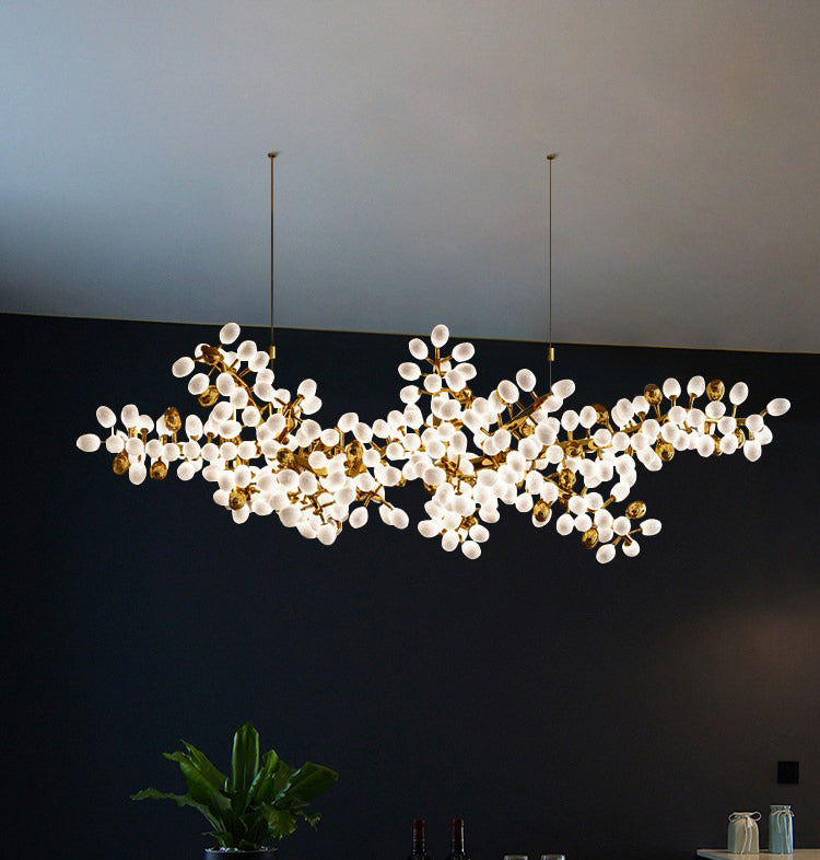 Organic white glass cluster chandelier hanging in a modern dining room
