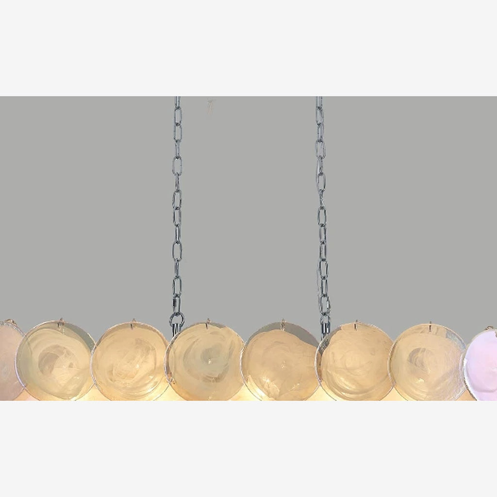 Colorful white glass disc chandelier with warm light on