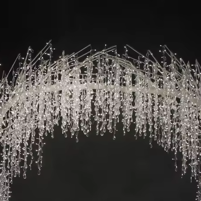 Close-up of LED crystal tree light arch branches with crystal pendants and LED string lights, luxury sparkle effect for events