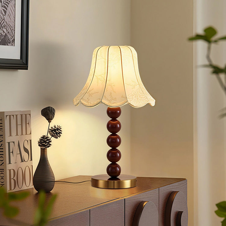 French floral fabric bedside lamp on cabinet in cozy interior