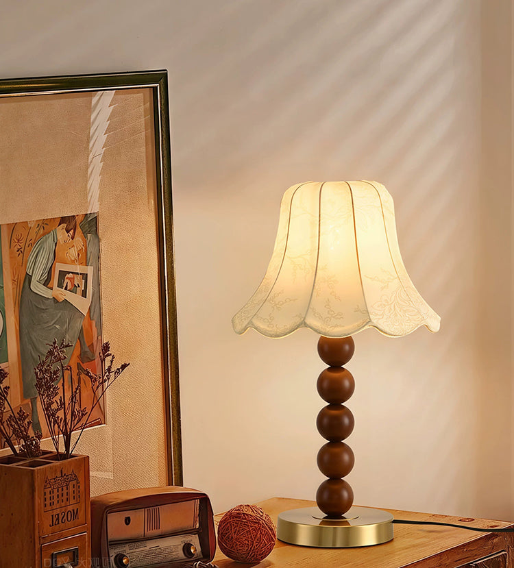 French floral fabric table lamp beside framed art on wooden cabinet
