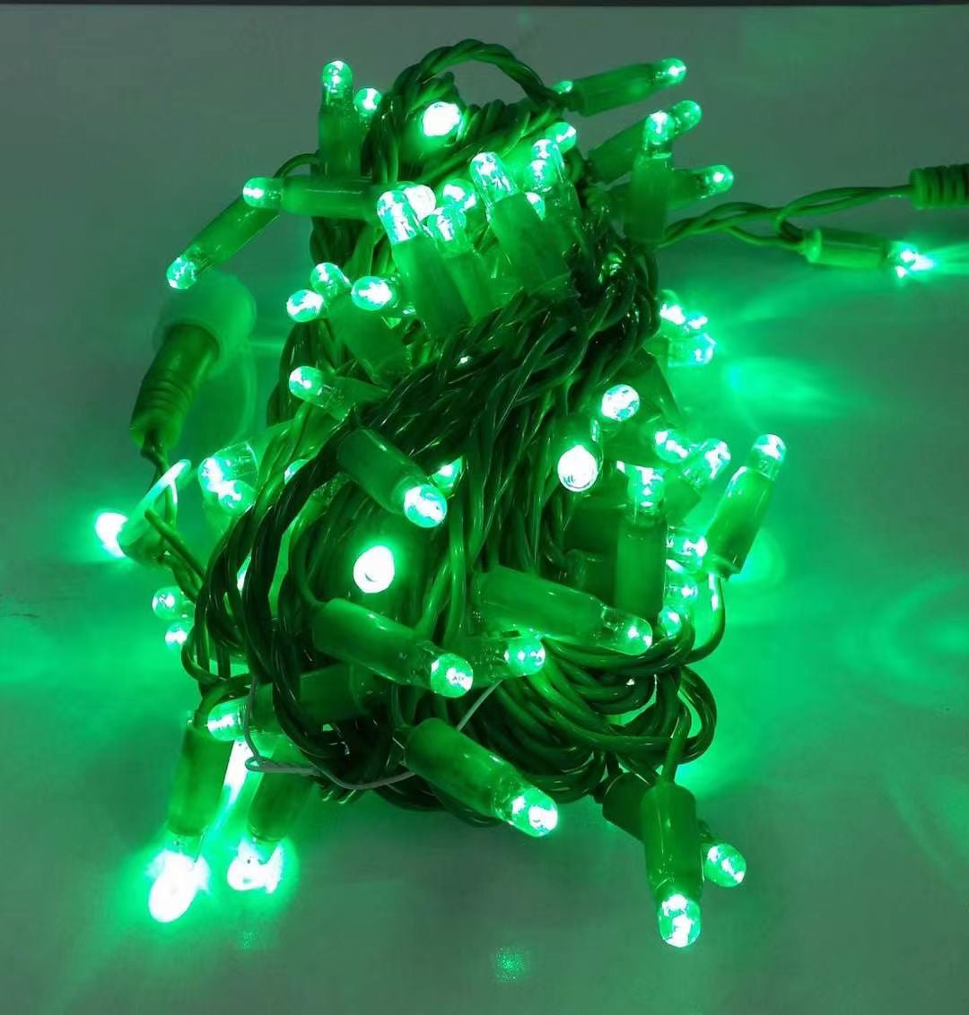Green rubber wire LED string lights with black wire close up