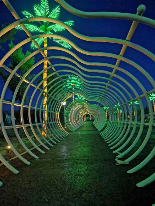 Outdoor decorative walkway installation with LED palm tree lights for parks and commercial landscapes