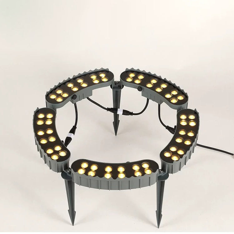 Five-head LED tree ring uplight showing the circular lamp arrangement, ground spikes and connecting cables.