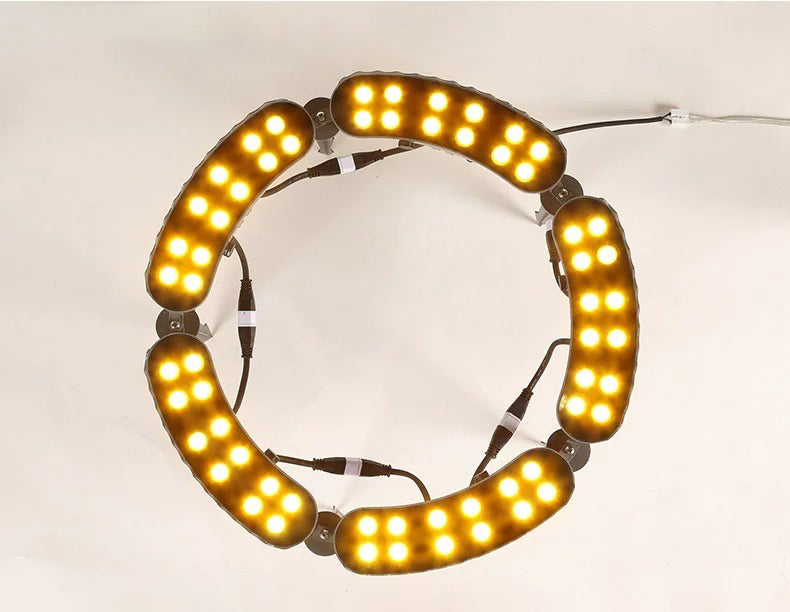 Top view of a five-head LED tree ring uplight with warm illumination and connected lamps arranged in a circle.