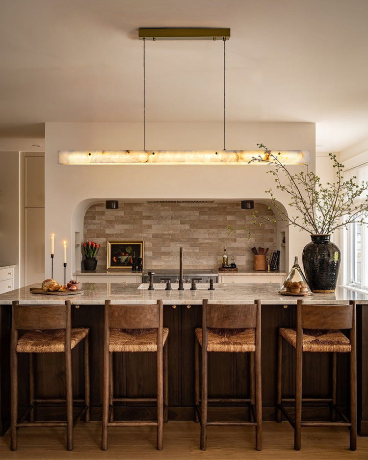 Natural stone linear pendant light installed above kitchen counter