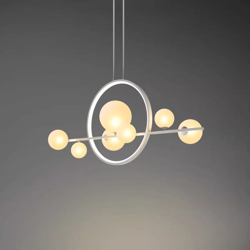 Nordic glass ball chandelier hanging above dining table in modern interior