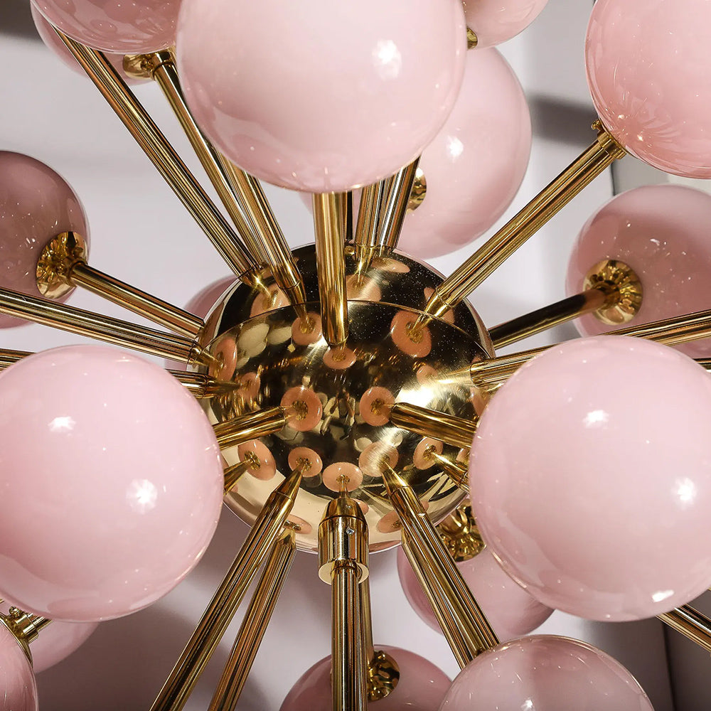 Close-up of frosted pink Murano glass shades on brass chandelier