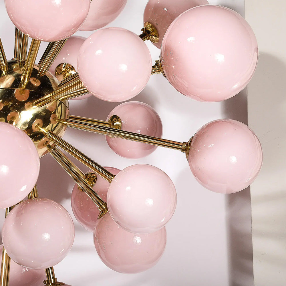 Close-up of frosted pink Murano glass shades on brass chandelier