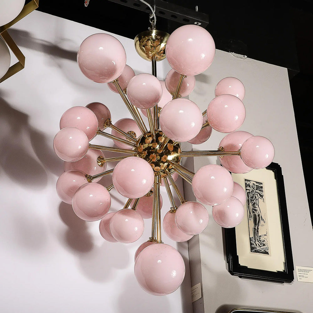 Close-up of frosted pink Murano glass shades on brass chandelier