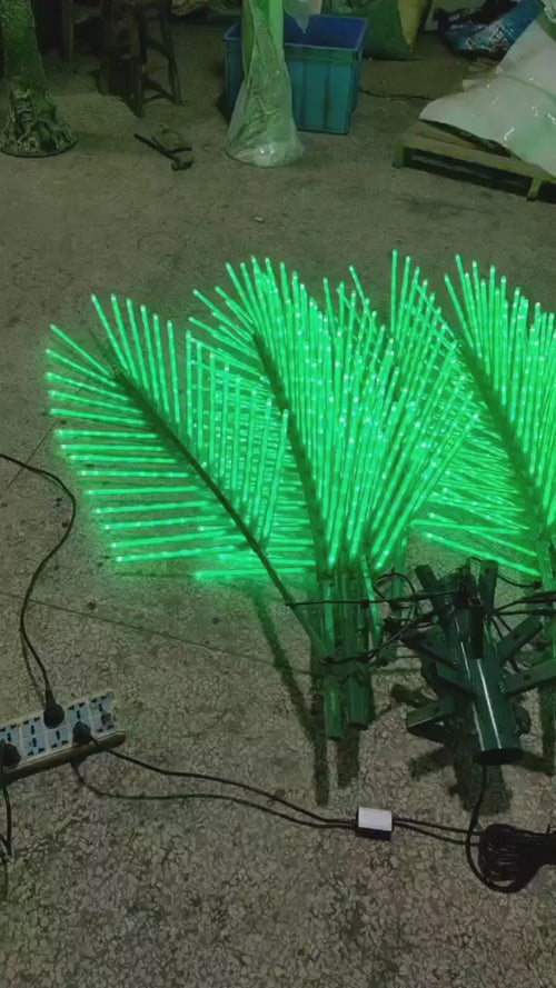 Glow-in-the-dark LED tree accents,Close-up of LED palm tree leaves showing bright, uniform lighting detail on the 2.5m model