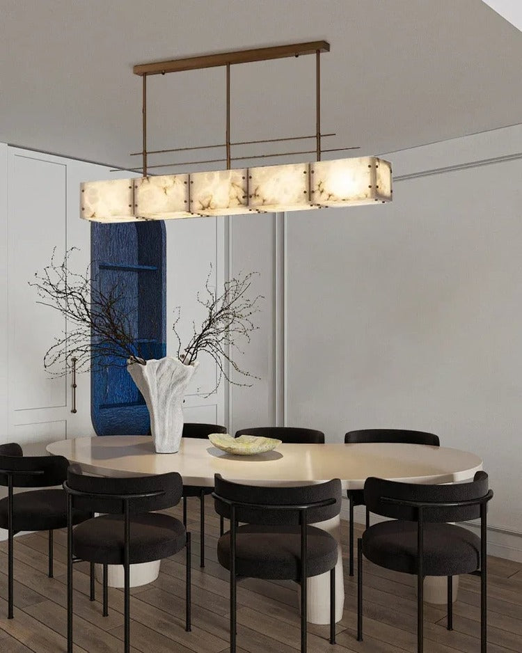 Rectangular alabaster brass chandelier above dining table in modern interior
