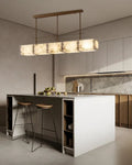 Rectangular alabaster brass chandelier over kitchen counter with warm light