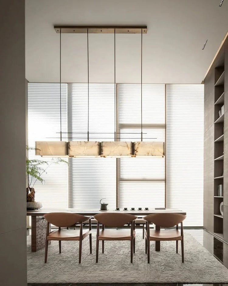 Long rectangular alabaster brass chandelier above dining room table