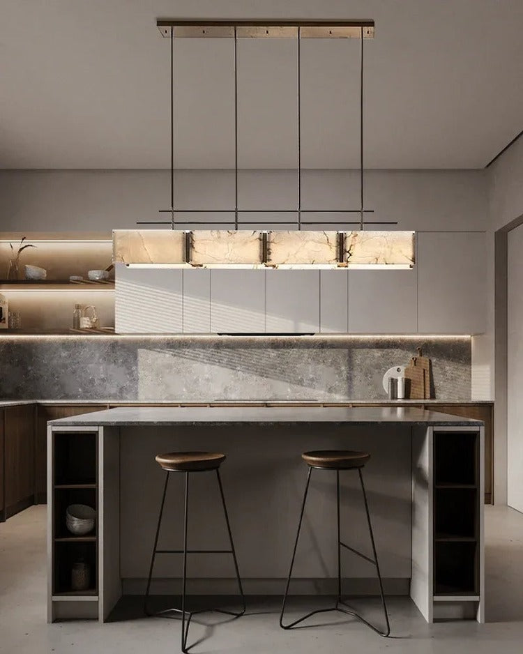 Rectangular alabaster brass chandelier above marble kitchen island