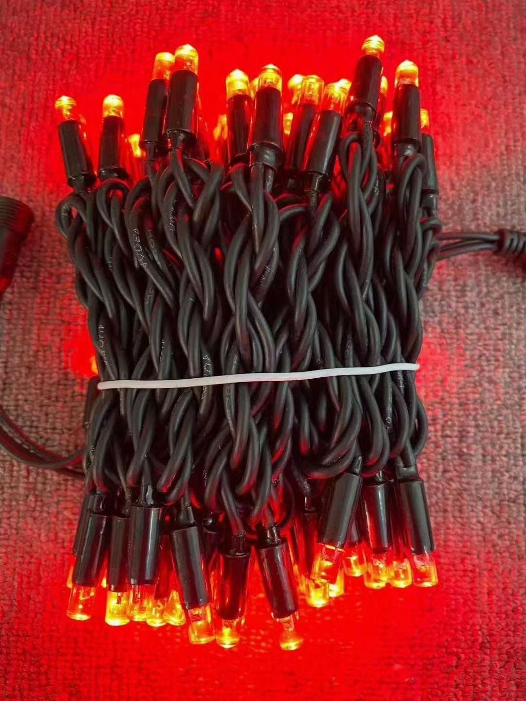 Red rubber wire LED string lights with black wire close up