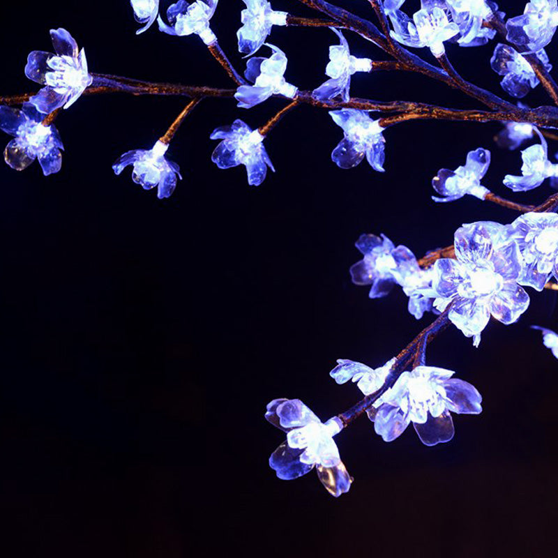 Close-up of illuminated cherry blossom flowers on RGBW LED tree light, bright and uniform glow for outdoor event decoration